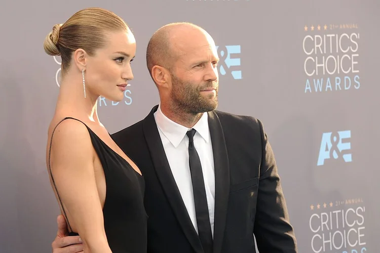 Jason Statham (dir.) acompanhado pela esposa, a modelo Rosie Huntington-Whiteley durante o Choice Awards (Gregg DeGuire/WireImage/Getty Images)