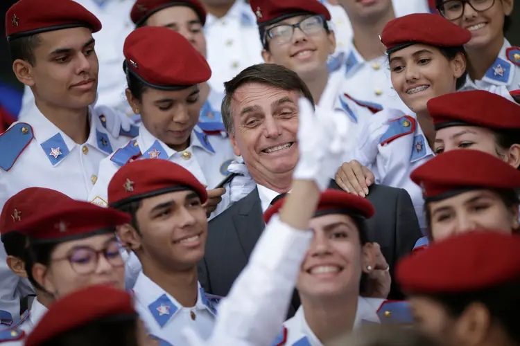 Federal deputy Jair Bolsonaro, a pre-candidate for Brazil's presidential elections, takes pictures with students of the military college during an Army Day ceremony, in Brasilia, Brazil April 19, 2018. REUTERS/Ueslei Marcelino (Ueslei Marcelino/Reuters)