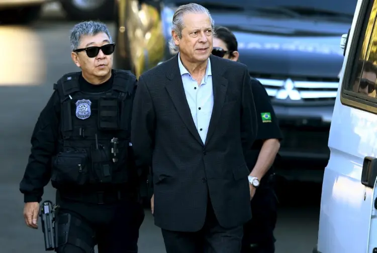 Ex-ministro José Dirceu é escoltado por policiais federais em Curitiba (Rodolfo Buhrer/Reuters)
