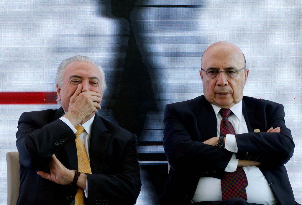 Brazil&#8217;s President Temer reacts next to presidential candidate of the MDB party, former Finance Minister Meirelles in Brasilia