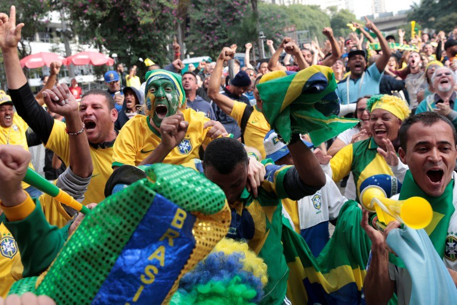 Fans celebrate a goal as they watch the broadcast of the World Cup Group E soccer match between Brazil and Switzerland, in Sao Paulo, Brazil June 17, 2018. REUTERS/Leonardo Benassatto