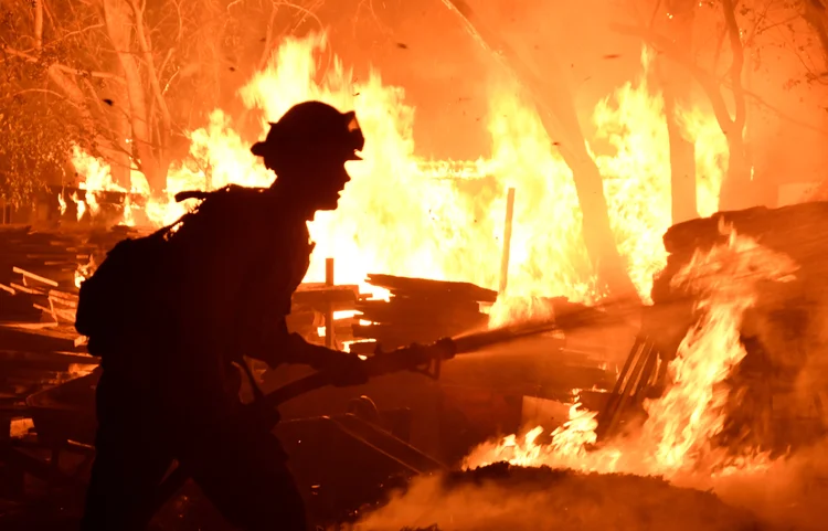 Bombeiros lutam contra um incêndio que destrói casas e obriga milhares de moradores a evacuarem na Califórnia.  (Gene Blevins/Reuters)