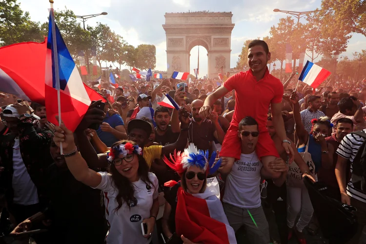 Fãs franceses reagem à segunda vitória de seu país na avenida Champs-Elysees, em Paris, França 
 (Gonzalo Fuentes/Reuters)