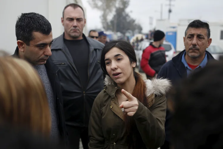 FILE PHOTO:  Nadia Murad Basee Taha, an Iraqi woman of the Yazidi faith who was abducted and held by the Islamic State for three months, walks through a makeshift camp for migrants and refugees at the Greek-Macedonian border near the village of Idomeni, Greece, April 3, 2016. REUTERS/Marko Djurica/File Photo (Marko Djurica/Reuters)