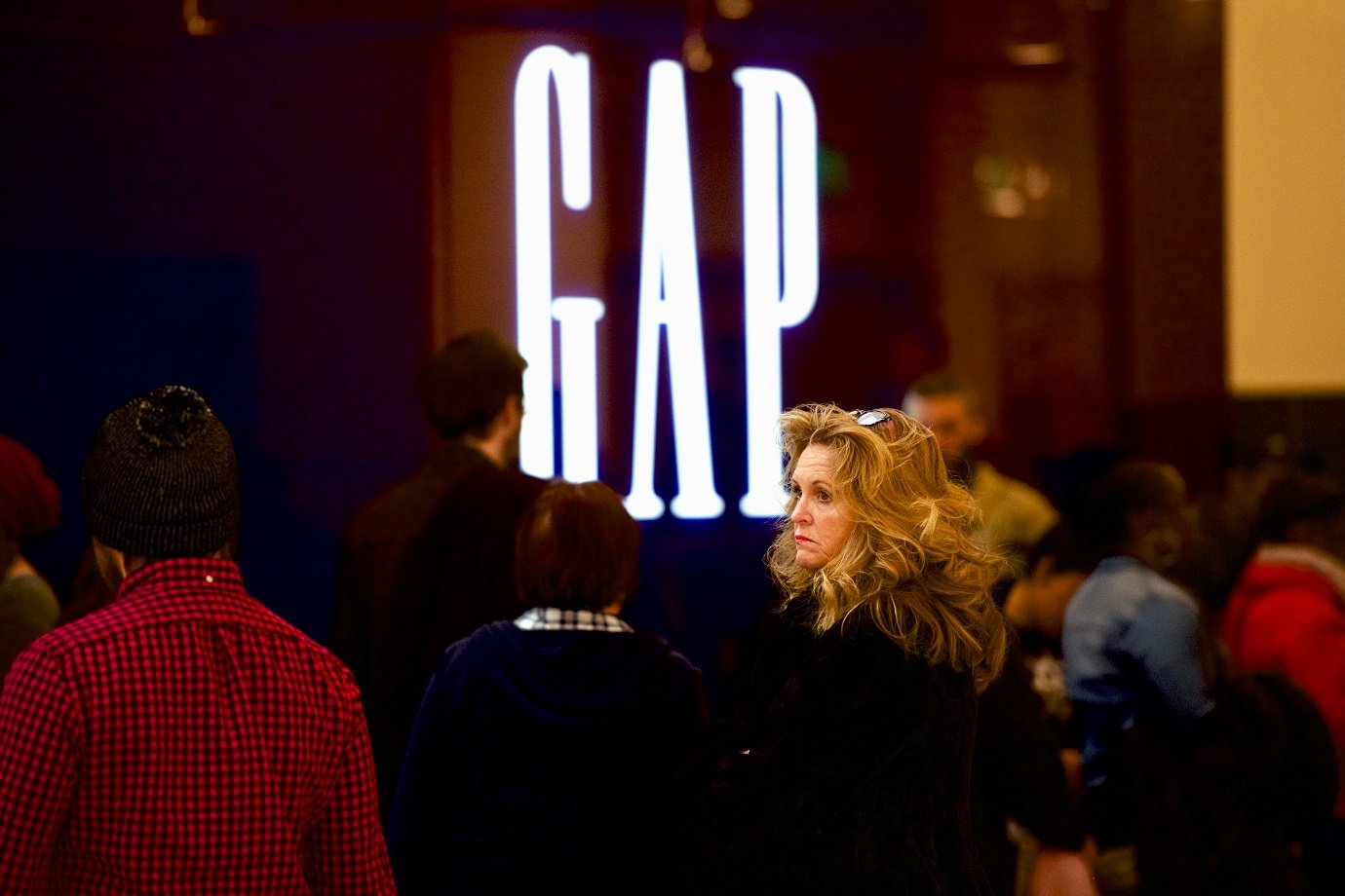 Shoppers line up for an elevator outside a GAP at the King of Prussia Mall, United States' largest retail shopping space, in King of Prussia