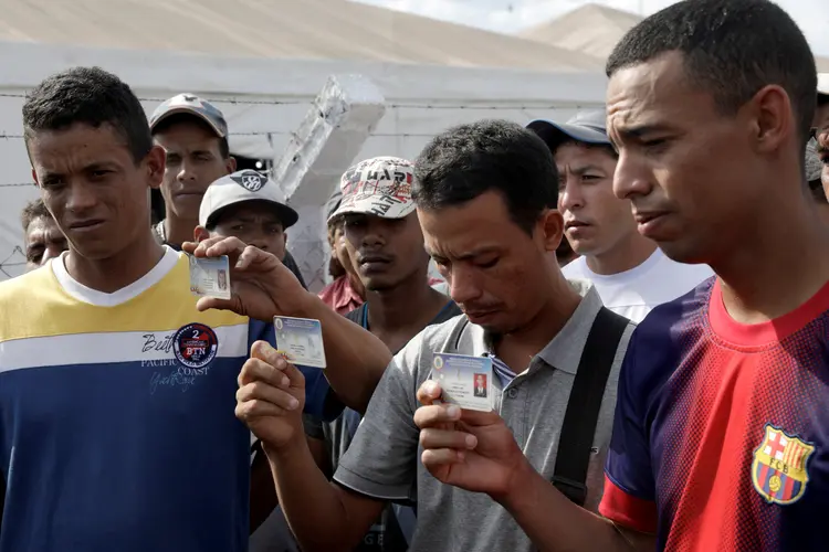 Membros da Guarda Nacional da Venezuela: Jean Carlos César Parra, Carlos Eduardo Zapata e Jorge Luis González Romero mostram suas identidades militares (Ricardo Moraes/Reuters)