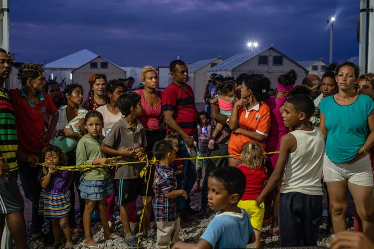 Refugiados Venezuelanos esperando pelo jantar no norte da Colômbia. Abril de 2019. Foto: Federico Rios / Bloomberg (Federico Rios/Bloomberg)