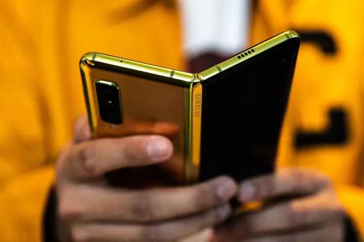 An attendee holds a Samsung Electronics Co. Galaxy Fold mobile device during an unveiling event for the Samsung Electronics Co. Galaxy Fold mobile device in New York, U.S., on Monday, April 15, 2019. Samsung announced the phone in February and it goes on sale April 26 at the wallet-stretching price of $1,980. Photographer: Jeenah Moon/Bloomberg (Bloomberg/Bloomberg)