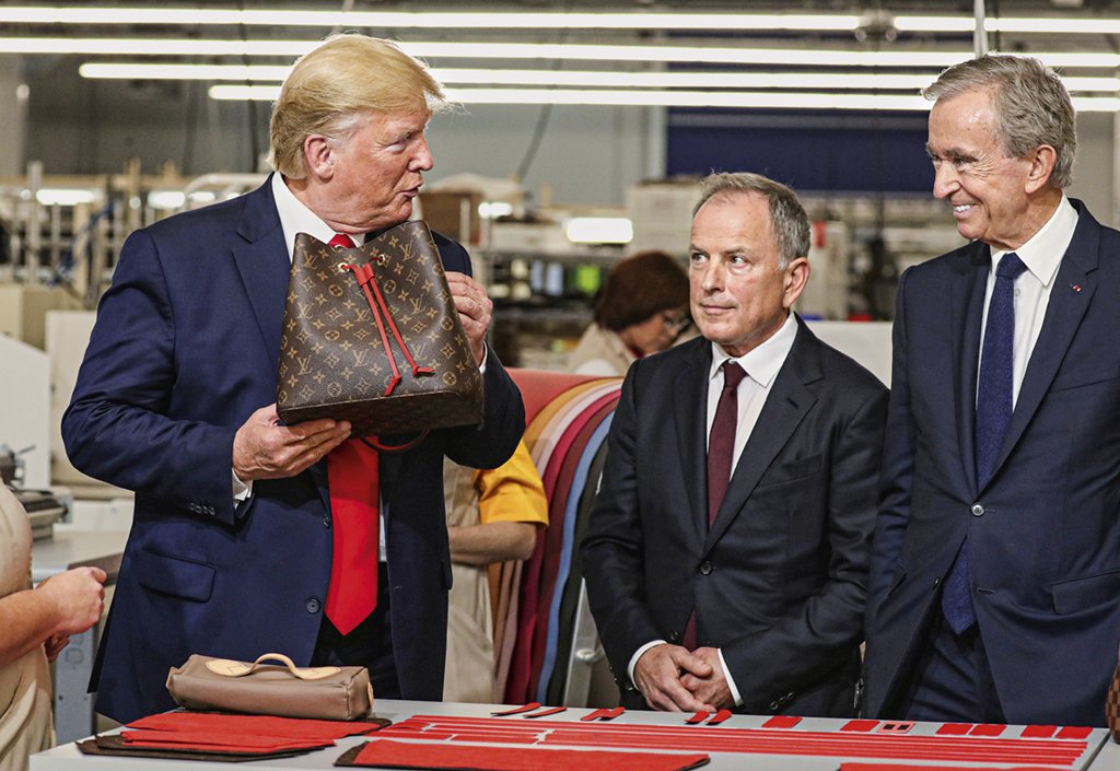 Trump com Burke e Arnault, da Louis Vuitton, na fábrica: protestos (Jonathan Ernst/Reuters)