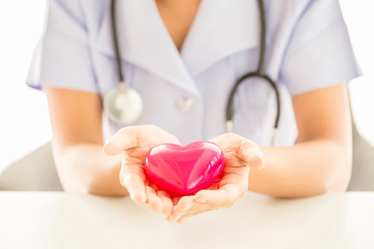 Female nurse with stethoscope holding heart, Healthcare and medical concept. (Designed by jcomp / Freepik.com/Creative Commons)