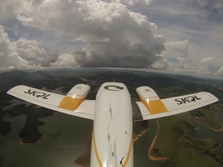 Avião sobrevoa a região do sistema Cantareira para despejar água no interior das nuvens (Skol -/Divulgação)