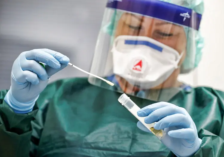 Canan Emcan, 31, chief nurse of the infection and virologist ward of the university clinic of Essen closes a sample of a smear test to be used in case of coronavirus patients during a media event in Essen, Germany, March 5, 2020.   REUTERS/Wolfgang Rattay (Wolfgang Rattay/Reuters)