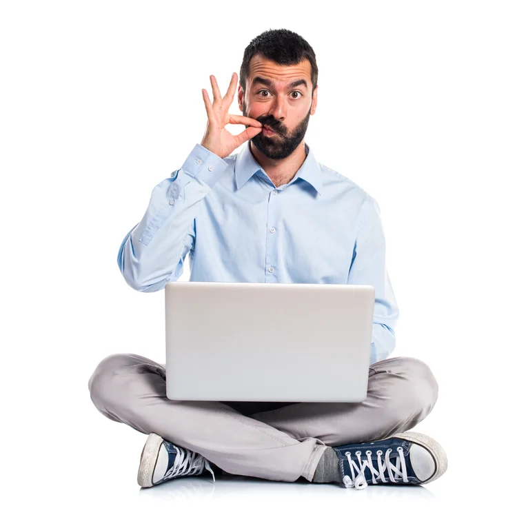 Man with laptop making silence gesture (Designed by luis_molinero / Freepik/Creative Commons)