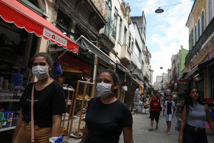 People wear protective masks as they walk by a street, amid coronavirus fears, in Rio de Janeiro, Brazil March 14, 2020. REUTERS/Pilar Olivares (Pilar Olivares/Reuters)