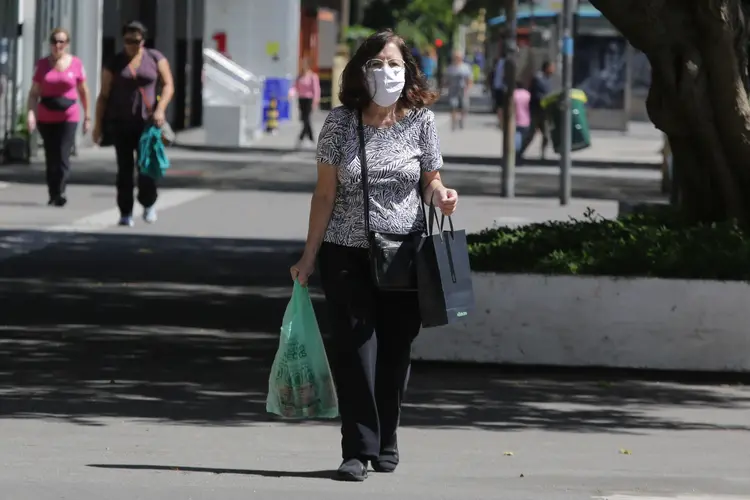 Mulher de máscara em São Paulo: Infecções virais como a causada pelo SARS-CoV-2 tendem a ativar o sistema imunológico do paciente infectado (NurPhoto/Getty Images)