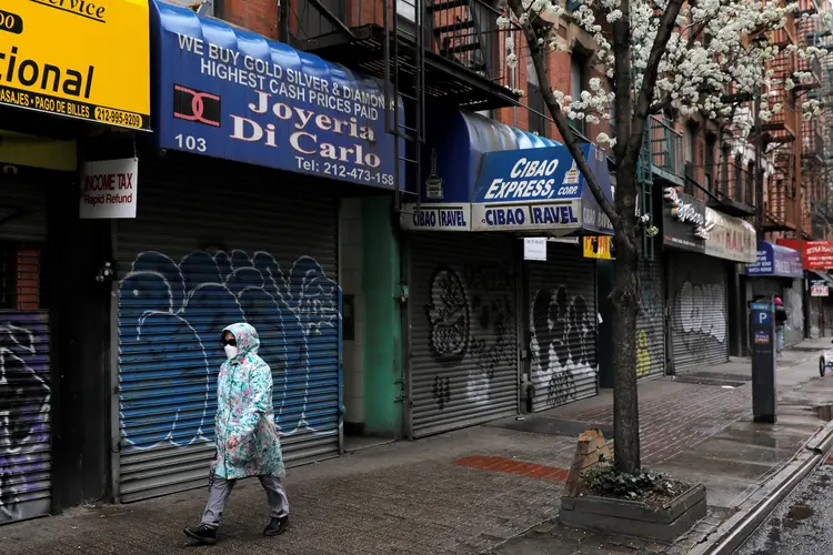 A person walks by rows of stores closed during the outbreak of the coronavirus disease (COVID-19) in Manhattan, New York City, U.S., March 28, 2020. REUTERS/Andrew Kelly (Andrew Kelly/Reuters)