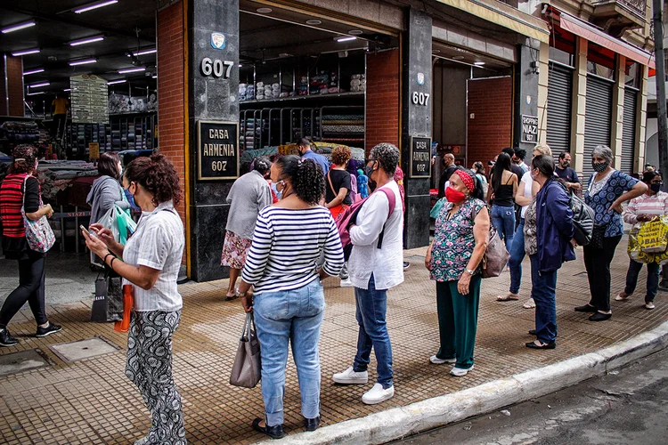 Fila para entrar nas lojas na rua 25 de Março em São Paulo: comércio de rua reabriu na cidade no dia 10 de junho (Ananda Migliano/O Fotográfico/Estadão Conteúdo)