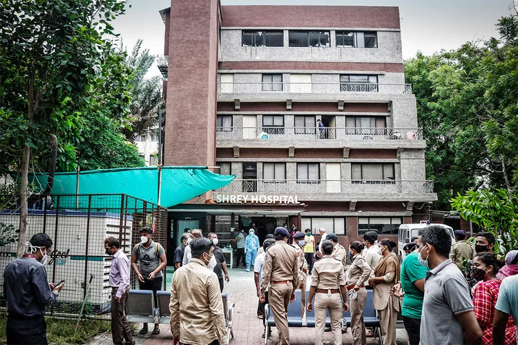 Policiais e familiares aguardam do lado de fora de hospital após incêndio na UTI matar pacientes com Covid-19 na Índia
06/08/2020 (Stringer/Reuters)