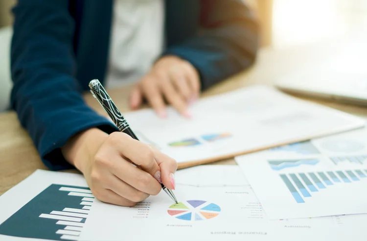 Business woman analyzing investment charts with laptop. Financial Accounting concept. (naruecha jenthaisong/Getty Images)