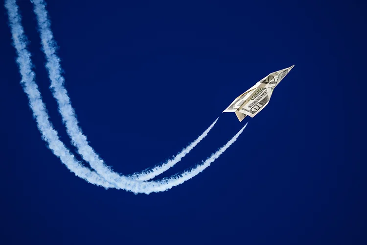 paper plane made from a ten dollar bill (LockieCurrie/Getty Images)