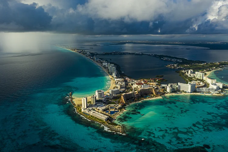 A rainstorm approaches hotels in Cancún, near Puerto Morelos, Mexico, on Nov. 15, 2020. In an unusual experiment, a coral reef in Mexico is now insured against hurricanes. A team of locals known as “the Brigade” rushed to repair the devastated corals, piece by piece. (Daniel Berehulak/The New York Times) (Daniel Berehulak/The New York Times)