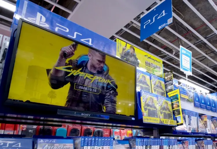 A screen showing a promotional video for the Cyberpunk 2077 game for the Sony Playstation is seen in the gaming section of a shop in Tokyo on December 18, 2020, as Sony announced the pulling of the much-hyped game from PlayStation stores around the world after a flood of complaints and ridicule over bugs, compatibility issues and even health risks. (Photo by Kazuhiro NOGI / AFP) (Photo by KAZUHIRO NOGI/AFP via Getty Images) (Kazuhiro Nogi/AFP/Getty Images)