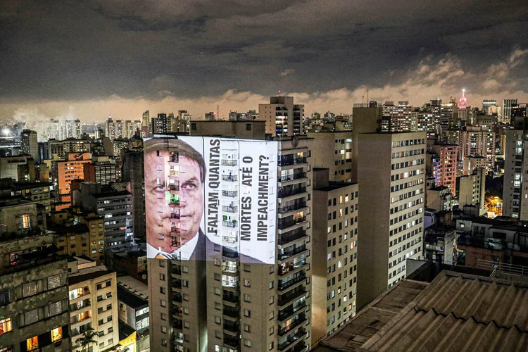 Uma imagem do presidente Jair Bolsonaro com a frase "Quantas mortes até o impeachment" é projetada em um prédio durante um protesto contra suas políticas para o surto de doença coronavírus (COVID-19) e crise de saúde de Manaus no bairro de Santa Cecília, em São Paulo , Brasil 15 de janeiro de 2021.  (Amanda Perobelli/Reuters)
