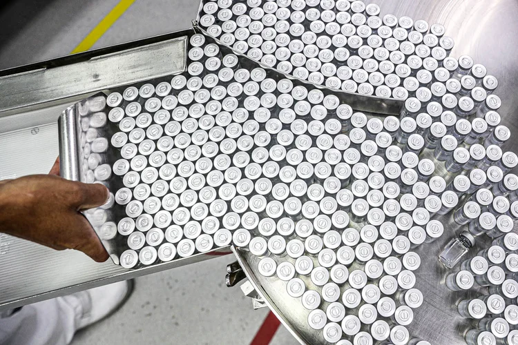 Funcionário coloca em equipamento frascos contendo CoronaVac, vacina da Sinovac contra coronavírus (COVID-19), no centro de produção biomédica do Butantan em São Paulo, Brasil, 22 de janeiro de 2021.  (Amanda Perobelli/Reuters)