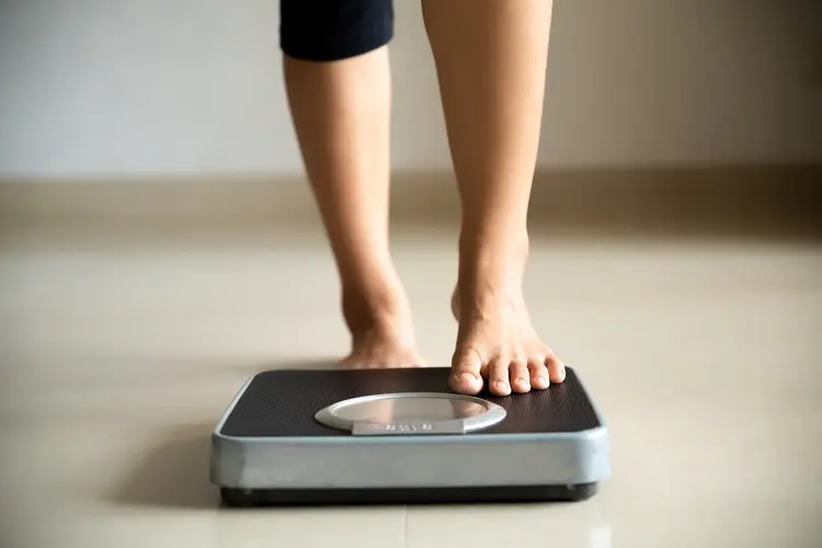 Female leg stepping on weigh scales. Healthy lifestyle, food and sport concept. (Getty Images/Getty Images)