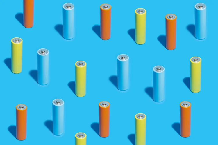 Elevated view of many multi colored batteries on a blue colored background (Javier Zayas Photography/Getty Images)