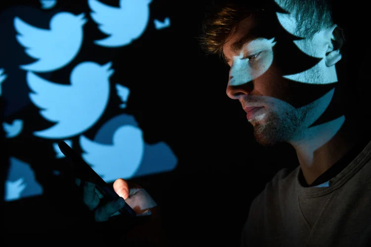 LONDON, ENGLAND - AUGUST 09:  In this photo illustration, the logo for the Twitter social media network is projected onto a man on August 09, 2017 in London, England. With around 328 million users worldwide, Twitter has gone from a small start-up in for the public 2006 to a broadcast tool of politicians and corporations in 2017.  (Photo by ) (Leon Neal/Getty Images)