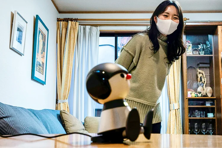 Nami Hamaura em sua casa em Tóquio com seu companheiro robô Charlie, 4 de fevereiro de 2021 (AFP/AFP)
