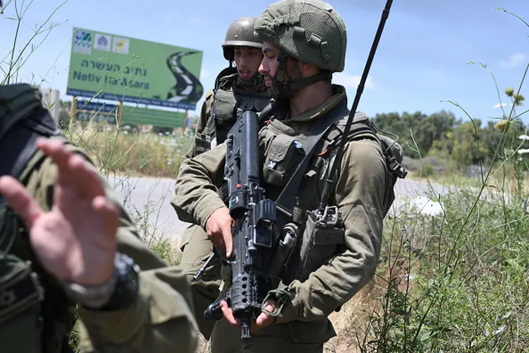 Israeli soldiers hold positions at Netiv Ha'Asara near the site where an IDF vehicle was directly hit by a rocket fired from Gaza strip, injuring 2 and killing one, in Netiv Ha'Asara. May 12, 2021.  (Photo by Gili Yaari/NurPhoto via Getty Images) (Gili Yaari/Getty Images)