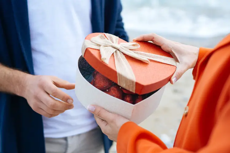 Hands Giving Heart Shaped Gift Close-up (Burak Karademir/Getty Images)