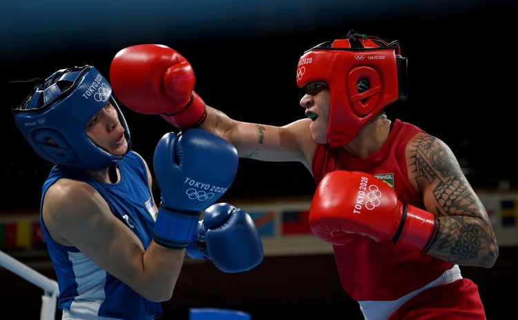 TOKYO, JAPAN - AUGUST 03: Beatriz Ferreira (red) of Team Brazil exchanges punches with Raykhona Kodirova of Team Uzbekistan during the Women's Light (57-60kg) quarter final on day eleven of the Tokyo 2020 Olympic Games at Kokugikan Arena on August 03, 2021 in Tokyo, Japan. (Photo by Dan Mullan/Getty Images) (Dan Mullan/Getty Images)