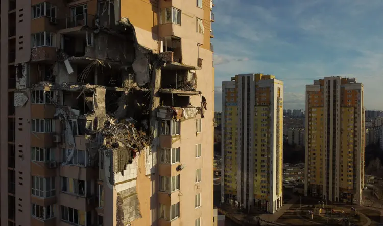 This general view shows damage to the upper floors of a building in Kyiv on February 26, 2022, after it was reportedly struck by a Russian rocket.. - Russia on February 26, 2022 ordered its troops to advance in Ukraine "from all directions" as the Ukrainian capital Kyiv imposed a blanket curfew and officials reported 198 civilian deaths. Kyiv residents took shelter to the sound of explosions as Ukraine's army said it had held back an assault on the capital but was fighting Russian "sabotage groups" which had infiltrated the city. (Photo by Daniel LEAL / AFP) (Photo by DANIEL LEAL/AFP via Getty Images) (DANIEL LEAL/AFP/Getty Images)