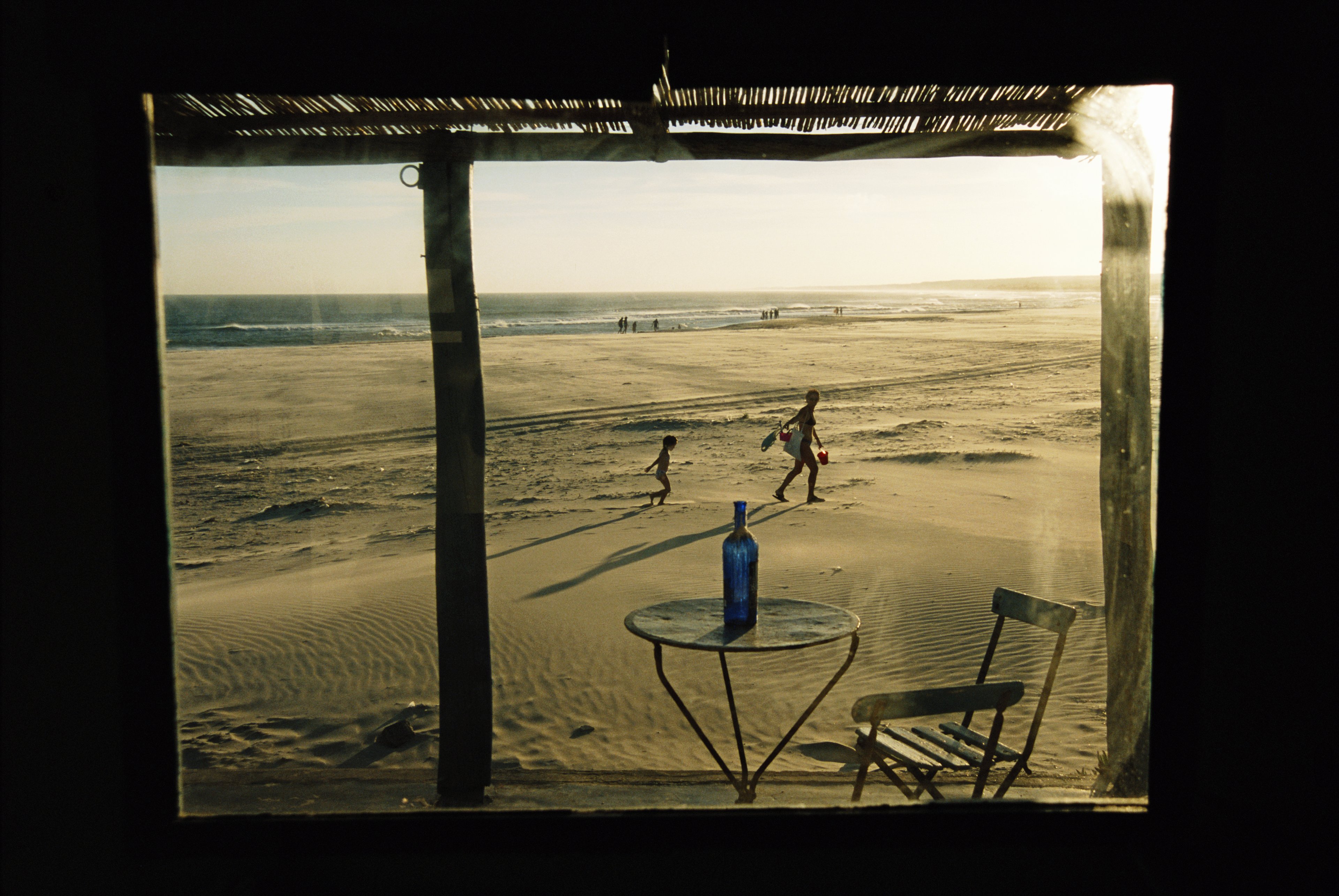 Uruguay, Cabo Polonio, people on beach, view through window