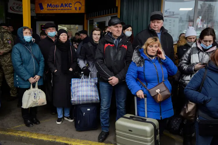 KYIV, UKRAINE - FEBRUARY 24: People wait for buses at a bus station as they attempt to evacuate the city on February 24, 2022 in Kyiv, Ukraine. Overnight, Russia began a large-scale attack on Ukraine, with explosions reported in multiple cities and far outside the restive eastern regions held by Russian-backed rebels. (Photo by Pierre Crom/Getty Images) (Pierre Crom/Getty Images)