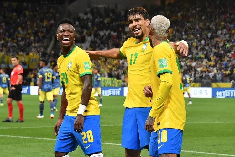 Brazil's Lucas Paqueta (C) celebrates with teammates Vinicius Junior (L) and Neymar after scoring against Colombia during the South American qualification football match for the FIFA World Cup Qatar 2022, at the Neo Quimica Arena, previously known as Arena Corinthians, in Sao Paulo, Brazil, on November 11, 2021. (Photo by NELSON ALMEIDA / AFP) (Photo by NELSON ALMEIDA/AFP via Getty Images) (NELSON ALMEIDA/AFP/Getty Images)