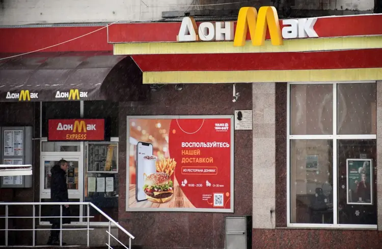 A man walks past a local fast food chain DonMac opened in a building of a former McDonalds restaurant in Donetsk on January 18, 2022, the capital of the self-proclaimed state of the Donetsk People's Republic (DPR) in eastern Ukraine. (Photo by Alexander NEMENOV / AFP) (Photo by ALEXANDER NEMENOV/AFP via Getty Images) (ALEXANDER NEMENOV/AFP/Getty Images)