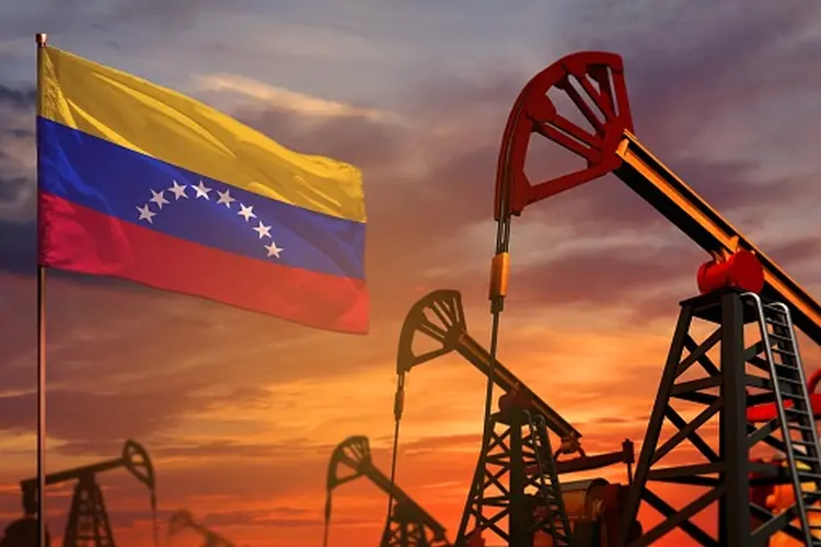 Venezuela oil industry concept, industrial illustration. Venezuela flag and oil wells and the red and blue sunset or sunrise sky background - 3D illustration (Getty Images/Getty Images)