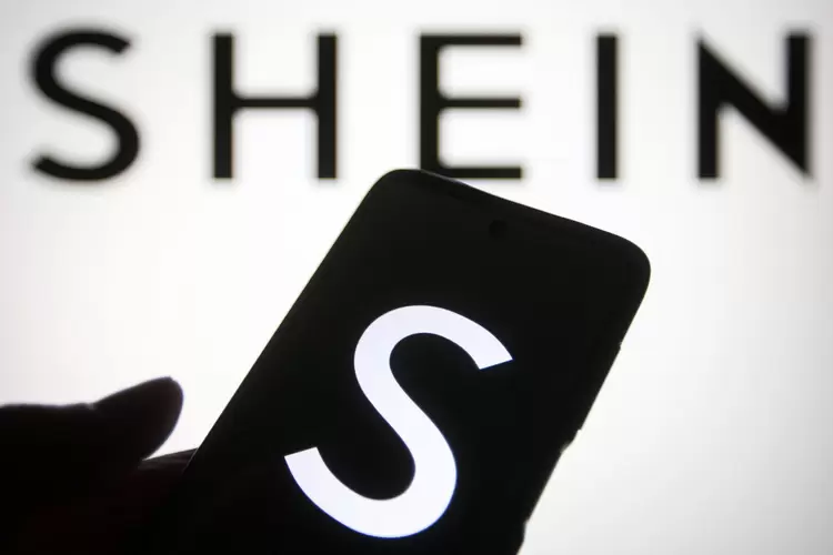UKRAINE - 2021/08/02: In this photo illustration a Shein logo of a Chinese online fashion and sports retailer is seen on a smartphone and a pc screen. (Photo Illustration by Pavlo Gonchar/SOPA Images/LightRocket via Getty Images) (Pavlo Gonchar/SOPA/Getty Images)