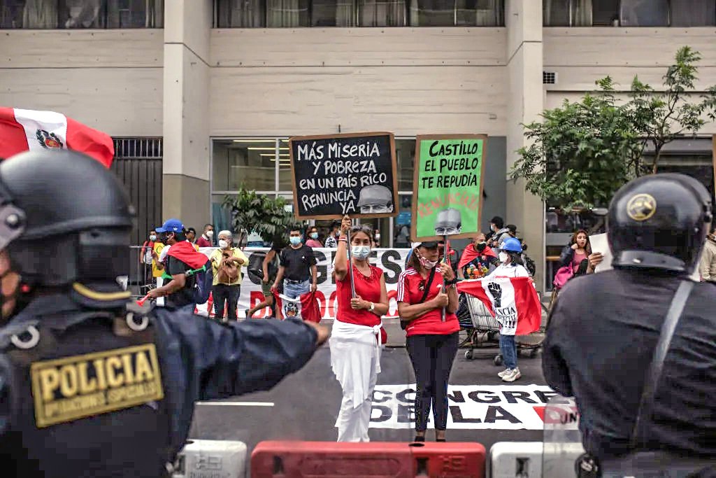Demonstrators against Peru's President Pedro Castillo hold signs outside the Legislative Palace in Lima, Peru, on Monday, March 28, 2022. Castillo faces the second impeachment attempt against him by the country's congress in eight months. Photographer: Angela Ponce/Bloomberg via Getty Images
