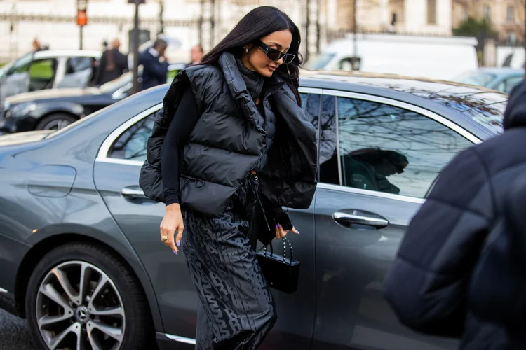 PARIS, FRANCE - JANUARY 20: Amina Muaddi seen wearing black vest, black pants with logo print outside Rains during Paris Fashion Week - Menswear F/W 2022-2023 on January 20, 2022 in Paris, France. (Photo by Christian Vierig/Getty Images) (Christian Vierig/Getty Images)