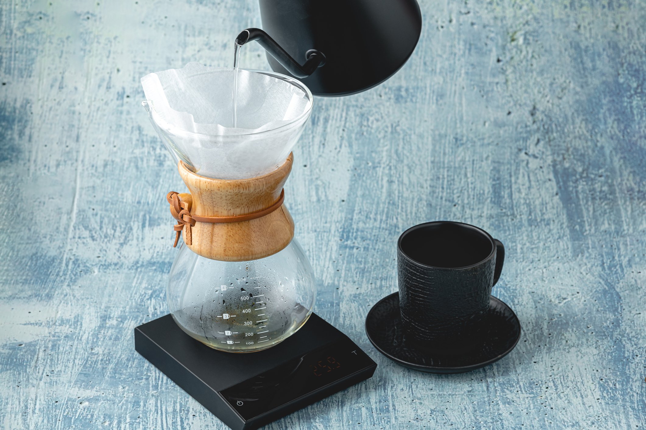 Professional barista brews coffee using chemex. Alternative ways to brew coffee. Coffee shop concept.