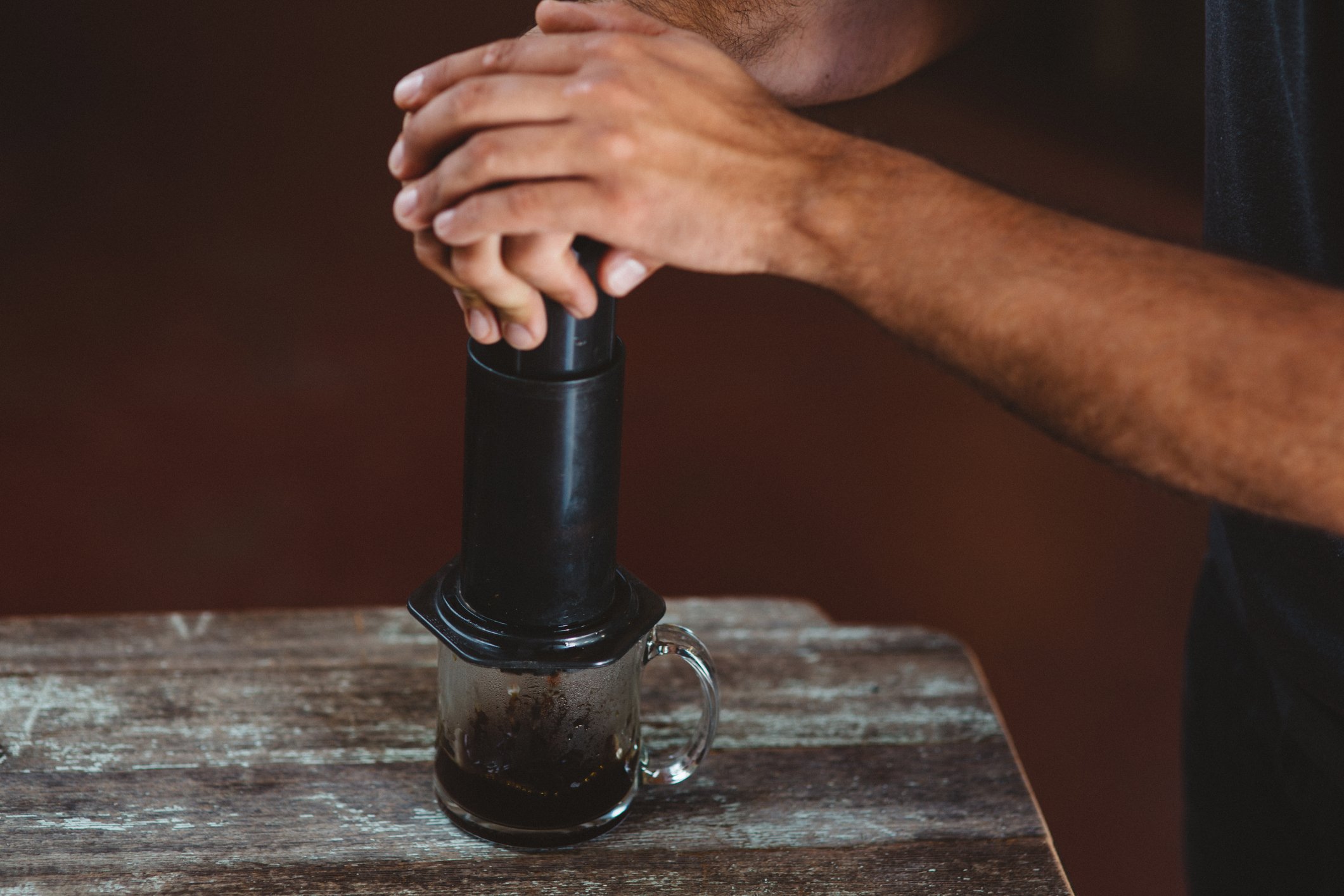 Man using aeropress coffee maker