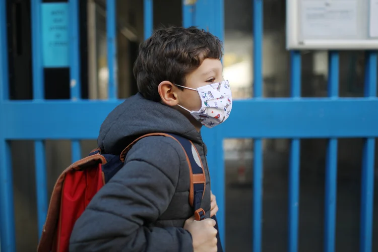 Child with protective face mask during COVID-19 pandemic (Catherine Delahaye/Getty Images)