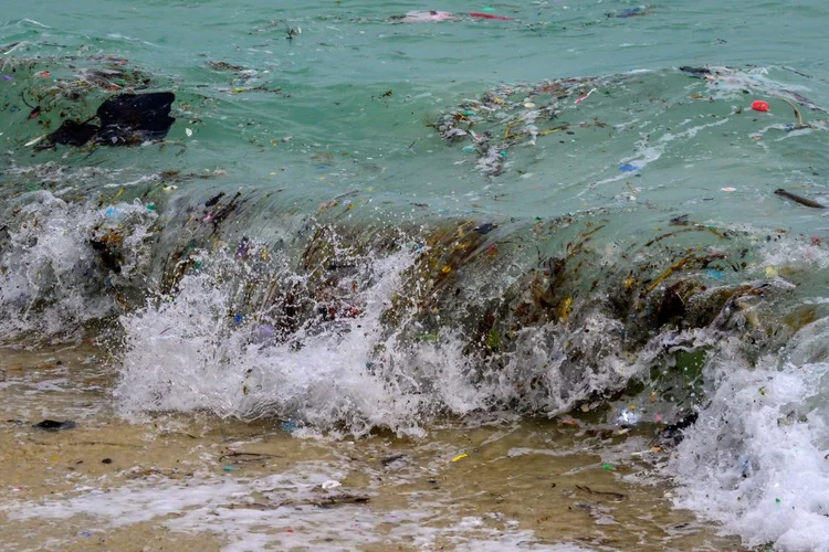 A wave carrying plastic waste and other rubbish washes up on a beach in Koh Samui in the Gulf of Thailand on January 19, 2021. (Photo by Mladen ANTONOV / AFP) (Photo by MLADEN ANTONOV/AFP via Getty Images) (MLADEN ANTONOV/Getty Images)