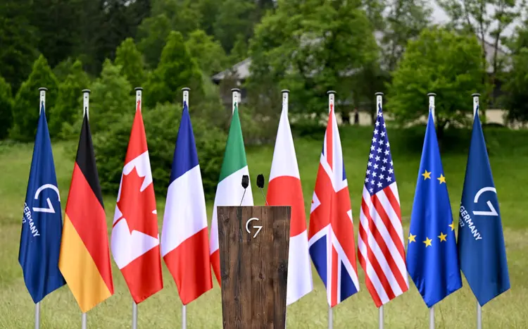 The flags of the G7 countries, the European Union and the 2022 G7 summit are seen behind a lectern on June 28, 2022 at Elmau Castle, southern Germany, prior to a closing press conference of the German Chancellor at the end of the G7 Summit. (Photo by KERSTIN JOENSSON / AFP) (Photo by KERSTIN JOENSSON/AFP via Getty Images) (Kerstin Joensson/Divulgação)