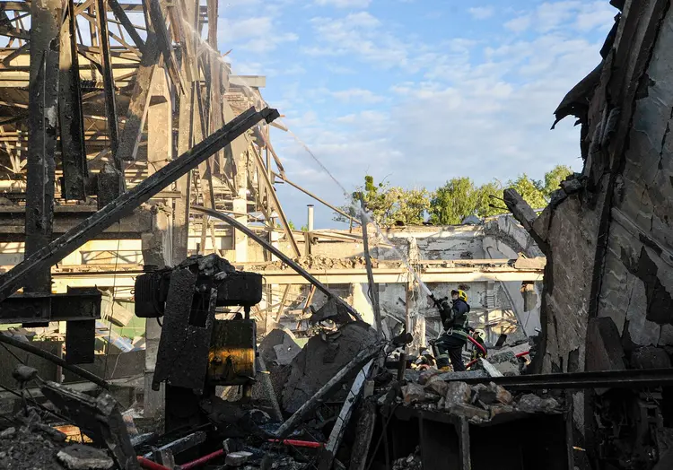 KYIV, UKRAINE - 2022/06/05: A fireman puts out debris from the Darnytskyi freight car repair plant destroyed by the missile attack by the Russian army. Russian aircraft fired missiles at Darnytskyi and Dniprovskyi districts in Kyiv. (Photo by Sergei Chuzavkov/SOPA Images/LightRocket via Getty Images) (Sergei Chuzavkov/SOPA Images/LightRocket/Getty Images)